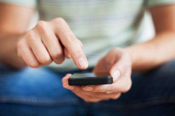 man-reading-book-of-mormon-on-phone